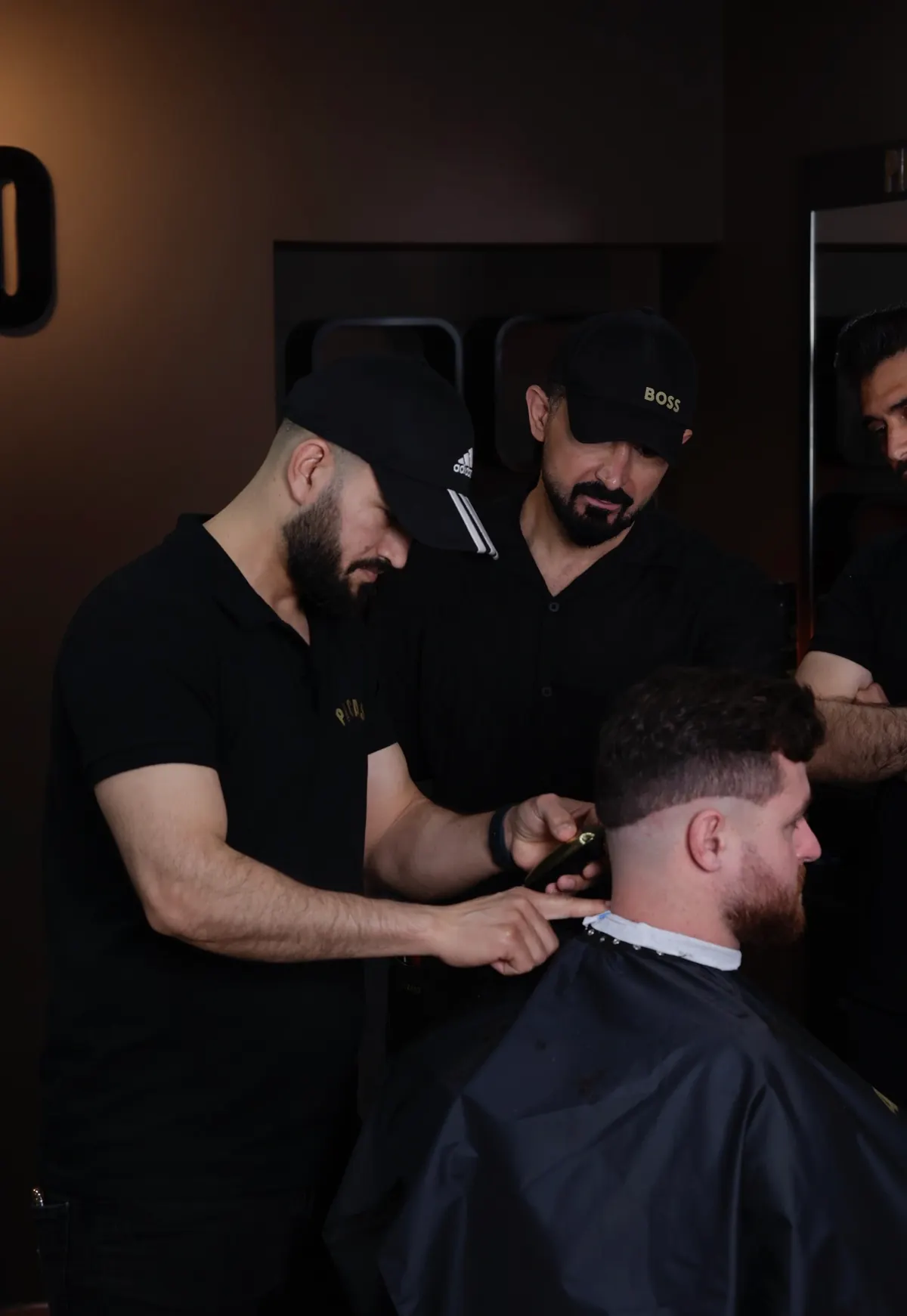 Barbering demonstration with a learner observing